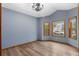 Dining room with wainscotting, wood-look flooring, and a modern chandelier beneath a cathedral ceiling at 9983 Cottoncreek Dr, Highlands Ranch, CO 80130