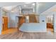 Open-concept entryway with wooden staircase and hardwood floors leading to the modern living area at 9983 Cottoncreek Dr, Highlands Ranch, CO 80130