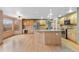 Open kitchen features an island with seating, stainless steel appliances, hardwood floors, and a casual dining area at 9983 Cottoncreek Dr, Highlands Ranch, CO 80130