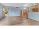 Spacious open-concept living area features wood-look flooring, ample light and light blue walls at 9983 Cottoncreek Dr, Highlands Ranch, CO 80130