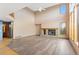 Bright living room with a soaring ceiling, a wood-burning fireplace and luxury vinyl plank flooring at 9983 Cottoncreek Dr, Highlands Ranch, CO 80130