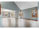 Bright and spacious living room with ample windows, light blue walls and a luxury vinyl plank floor at 9983 Cottoncreek Dr, Highlands Ranch, CO 80130