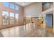 Bright living room features hardwood floors, large windows, and an open floor plan flowing into the kitchen at 9983 Cottoncreek Dr, Highlands Ranch, CO 80130