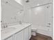A bright bathroom featuring a double vanity with white countertops, tile flooring, and a shower-tub combination at 250 Lark Sparrow Way, Bennett, CO 80102