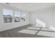 A bright bedroom featuring neutral carpeting, a large window with neighborhood views, and neutral paint at 250 Lark Sparrow Way, Bennett, CO 80102
