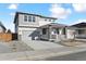 Inviting two-story home showcasing a covered porch with stone pillars, gray siding, and a spacious driveway at 250 Lark Sparrow Way, Bennett, CO 80102