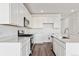 Contemporary kitchen with white cabinetry, quartz countertops, and stainless steel appliances at 250 Lark Sparrow Way, Bennett, CO 80102