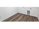 A laundry room featuring wood flooring, neutral paint, and washer hookups at 250 Lark Sparrow Way, Bennett, CO 80102