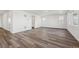 Spacious living room featuring wood-look floors, neutral walls, and ample natural light at 250 Lark Sparrow Way, Bennett, CO 80102
