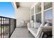 Relax on the inviting balcony, complete with a comfortable daybed, chairs, and a small table at 2851 W 52Nd Ave # 404, Denver, CO 80221