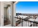 Balcony with a door, railing, and exterior view of rooftops and mountains in the distance at 2851 W 52Nd Ave # 404, Denver, CO 80221