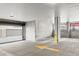 Spacious parking garage with concrete construction and a yellow directional arrow painted on the floor at 2851 W 52Nd Ave # 404, Denver, CO 80221