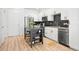 Spacious kitchen with white cabinetry, modern appliances, and a functional island with seating at 2851 W 52Nd Ave # 404, Denver, CO 80221