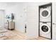 Bright laundry area features stacked washer and dryer, conveniently located near the open living space at 2851 W 52Nd Ave # 404, Denver, CO 80221