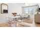 Bright living area featuring a dining table and large windows with natural light and city views at 2851 W 52Nd Ave # 404, Denver, CO 80221