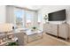 Cozy living room area with a gray sofa, modern table, light floors, and large windows at 2851 W 52Nd Ave # 404, Denver, CO 80221