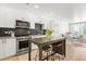 Open concept kitchen and living space with modern appliances and stylish accents at 2851 W 52Nd Ave # 404, Denver, CO 80221