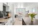 Open-concept living space with modern kitchen, dining area, and bright living room with natural light at 2851 W 52Nd Ave # 404, Denver, CO 80221