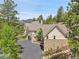 Expansive estate nestled among lush trees with a long driveway and mountain views at 4158 Wild Flower Ct, Evergreen, CO 80439
