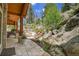 Beautiful stone patio with lush landscaping leading to upper levels; inviting outdoor retreat at 4158 Wild Flower Ct, Evergreen, CO 80439