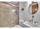 Bathroom with a tiled glass enclosed shower, toilet, and vanity with a round mirror at 4158 Wild Flower Ct, Evergreen, CO 80439