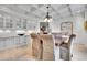 An elegant dining room features a coffered ceiling, built-in cabinetry and detailed, upholstered chairs at 4158 Wild Flower Ct, Evergreen, CO 80439