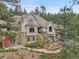 Elegant stone-accented home with manicured landscaping and inviting stairway at 4158 Wild Flower Ct, Evergreen, CO 80439