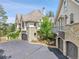 Stunning multi-story home with stone accents, multiple garages, and lush landscaping at 4158 Wild Flower Ct, Evergreen, CO 80439