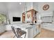 Open concept kitchen featuring stone countertops, modern appliances and a connected living space with fireplace at 4158 Wild Flower Ct, Evergreen, CO 80439