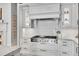 Gourmet kitchen features a stainless steel range, decorative tile backsplash, and custom cabinetry at 4158 Wild Flower Ct, Evergreen, CO 80439