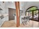 A bright kitchen with large windows, an island with seating, and stainless steel appliances at 4158 Wild Flower Ct, Evergreen, CO 80439