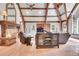 Cozy living room showcasing a stone fireplace, beamed ceilings, and stylish furnishings at 4158 Wild Flower Ct, Evergreen, CO 80439