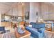 Open-concept living space showcases wood walls, kitchenette, sitting area and a queen bed at 4158 Wild Flower Ct, Evergreen, CO 80439