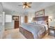 Comfortable bedroom with wooden furnishings, neutral walls, and updated ceiling fan at 4158 Wild Flower Ct, Evergreen, CO 80439
