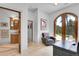 Cozy office with desk, chair, french doors, tile floors and views into a bathroom at 4158 Wild Flower Ct, Evergreen, CO 80439