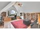 Bright office with custom built-ins, large windows, neutral paint, and a red oriental rug at 4158 Wild Flower Ct, Evergreen, CO 80439