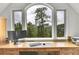Home office featuring a built-in desk and a picturesque view of the surrounding trees and mountains at 4158 Wild Flower Ct, Evergreen, CO 80439