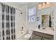Bathroom features a shower with a tile surround, vanity, and new fixtures at 12301 Festival Ln, Thornton, CO 80241