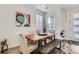 Inviting dining area with a wooden table, chairs, bench, modern decor, and natural light at 12301 Festival Ln, Thornton, CO 80241