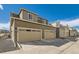 Exterior view of townhomes with multiple garages and modern design at 12301 Festival Ln, Thornton, CO 80241
