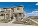 Two-story townhome with a covered porch and modern exterior finishes at 12301 Festival Ln, Thornton, CO 80241