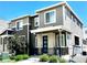 Modern two-story home featuring a stylish facade, stone accents, and a welcoming front porch at 12301 Festival Ln, Thornton, CO 80241