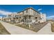 Street view of modern townhomes with well-maintained landscaping at 12301 Festival Ln, Thornton, CO 80241