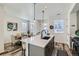 Bright kitchen showcasing a center island, stainless steel appliances, and an adjacent dining area at 12301 Festival Ln, Thornton, CO 80241