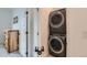 A stacked washer and dryer unit is conveniently located near a storage cabinet at 12301 Festival Ln, Thornton, CO 80241