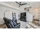 Relaxing living room with a sofa, TV, fireplace, decorative ladder, and stylish rug at 12301 Festival Ln, Thornton, CO 80241