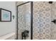 Bathroom shower features decorative tiles and a frameless glass door at 12301 Festival Ln, Thornton, CO 80241