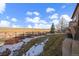 Picturesque backyard with a wooden fence line, trees and adjacent land at 15789 W 95Th Pl, Arvada, CO 80007