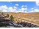 Enjoy this backyard view with distant mountains and a wooden fence line at 15789 W 95Th Pl, Arvada, CO 80007