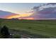 Beautiful sunset view overlooking an expansive green field at 15789 W 95Th Pl, Arvada, CO 80007